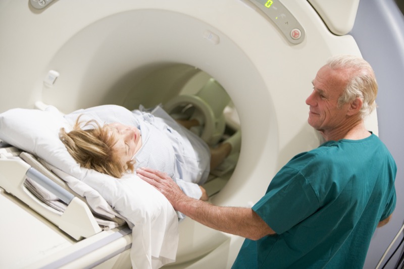 Doctor With Patient As They Prepare For A Computerized Axial Tomography (CAT) Scan