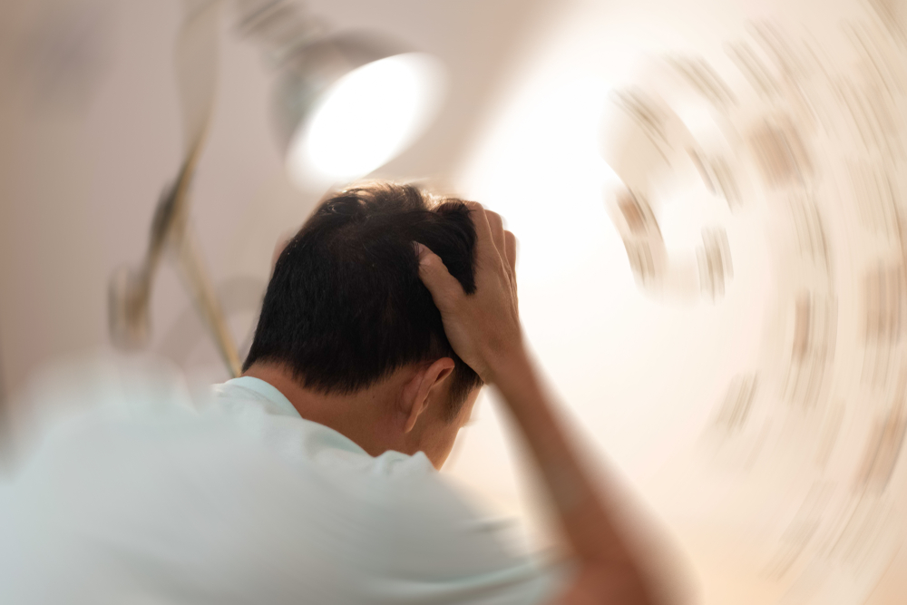 Man hands on his head felling headache dizzy sense of spinning dizziness