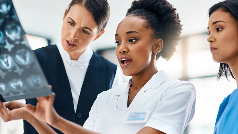 Hospital, team and doctors checking MRI results for diagnosis, advice or consultation with smile. Healthcare, neurology and brain scan review with medical professional, woman and nurse at clinic.