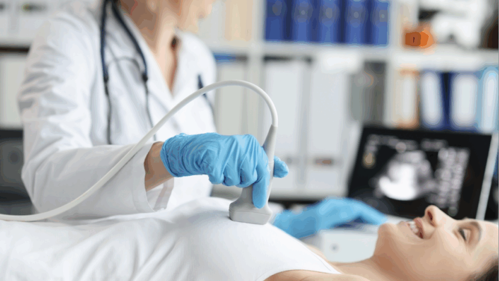 Doctor doing ultrasound examination of breast of patient in clinic