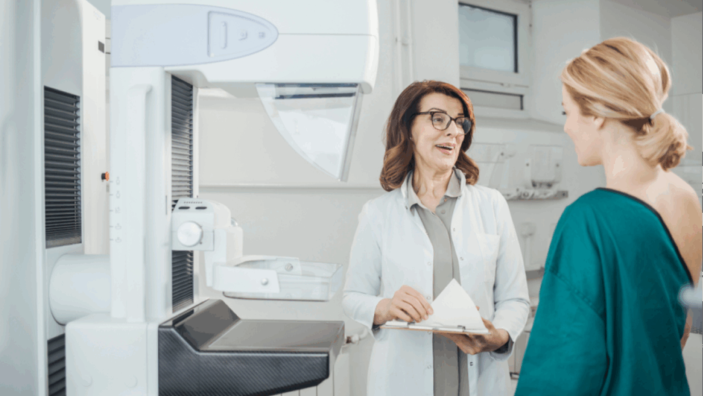 Woman oncologist talking with her patient on mammography examination.