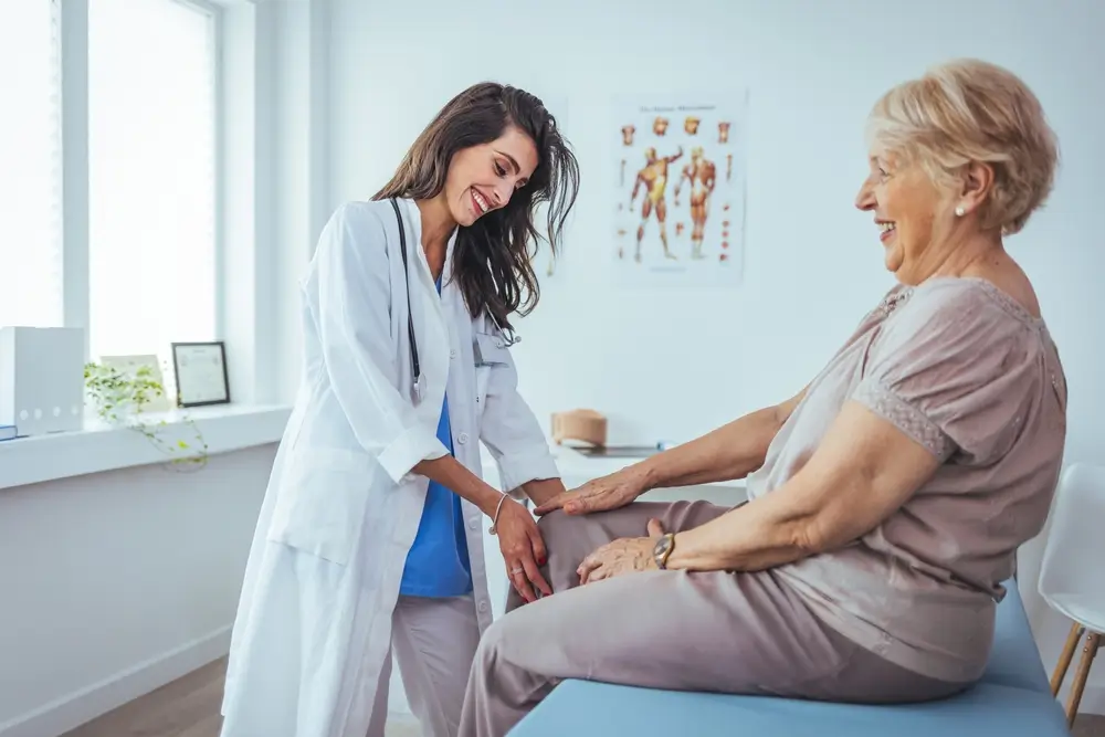 Doctor examining patient knee.